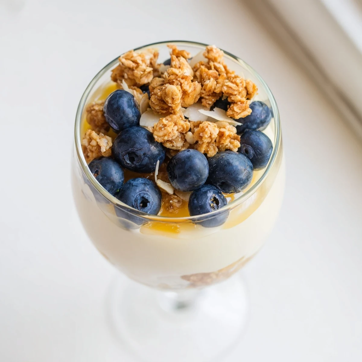 Serve this refreshing Lemon Blueberry Yogurt Parfait for breakfast or dessert, layered with juicy berries and honey-sweetened granola.