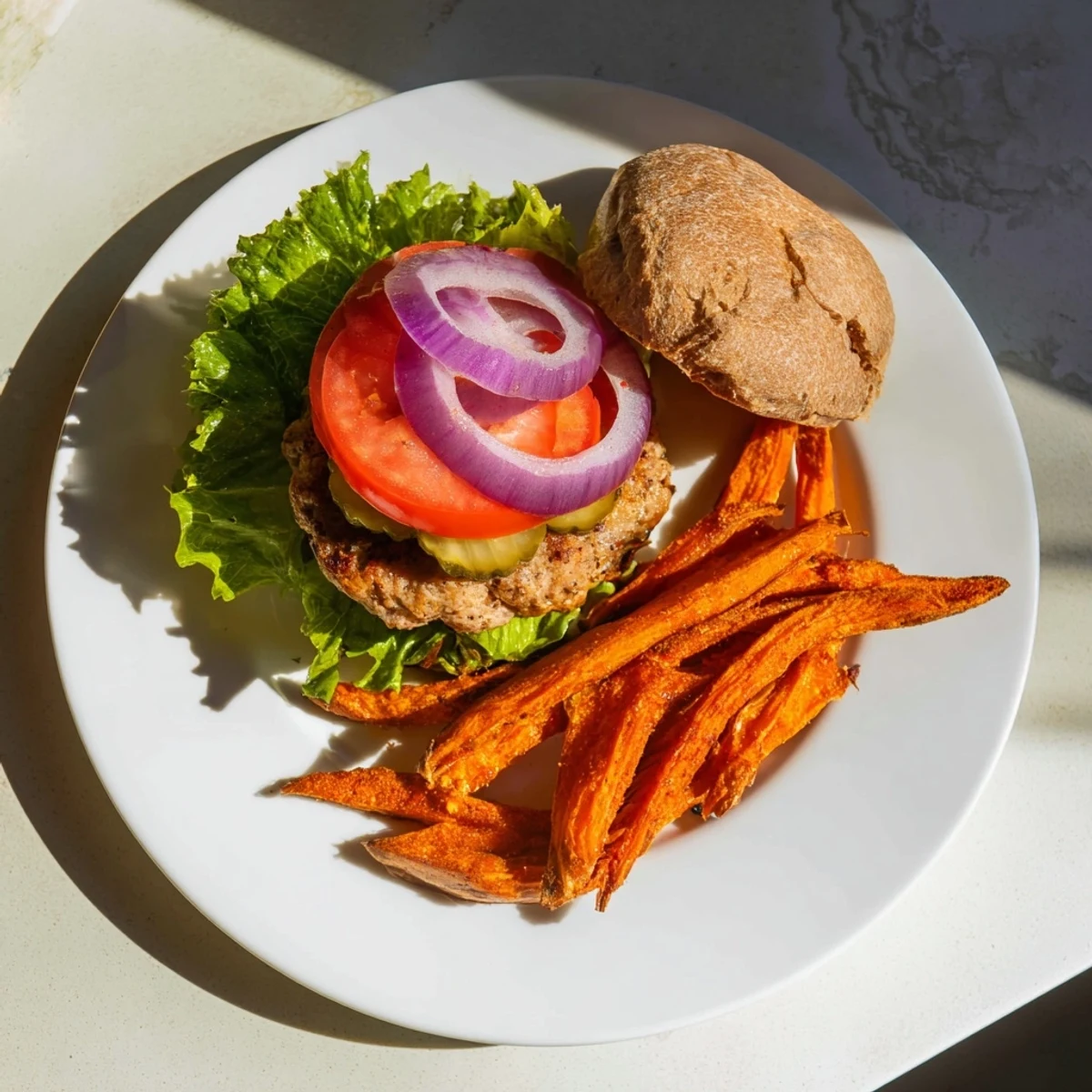A close-up of a juicy turkey burger on a whole wheat bun with crispy sweet potato fries, showcasing a wholesome, family-friendly dinner.