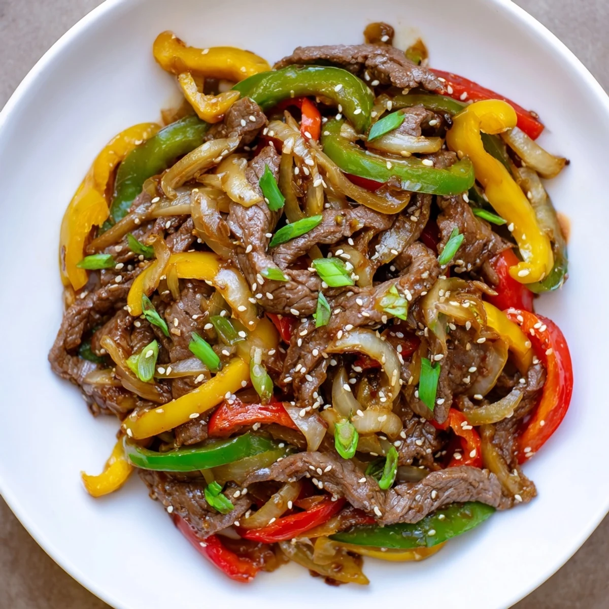Vibrant Spicy Beef and Pepper Stir Fry showcases colorful bell peppers and tender beef coated in a glossy, savory sauce.  