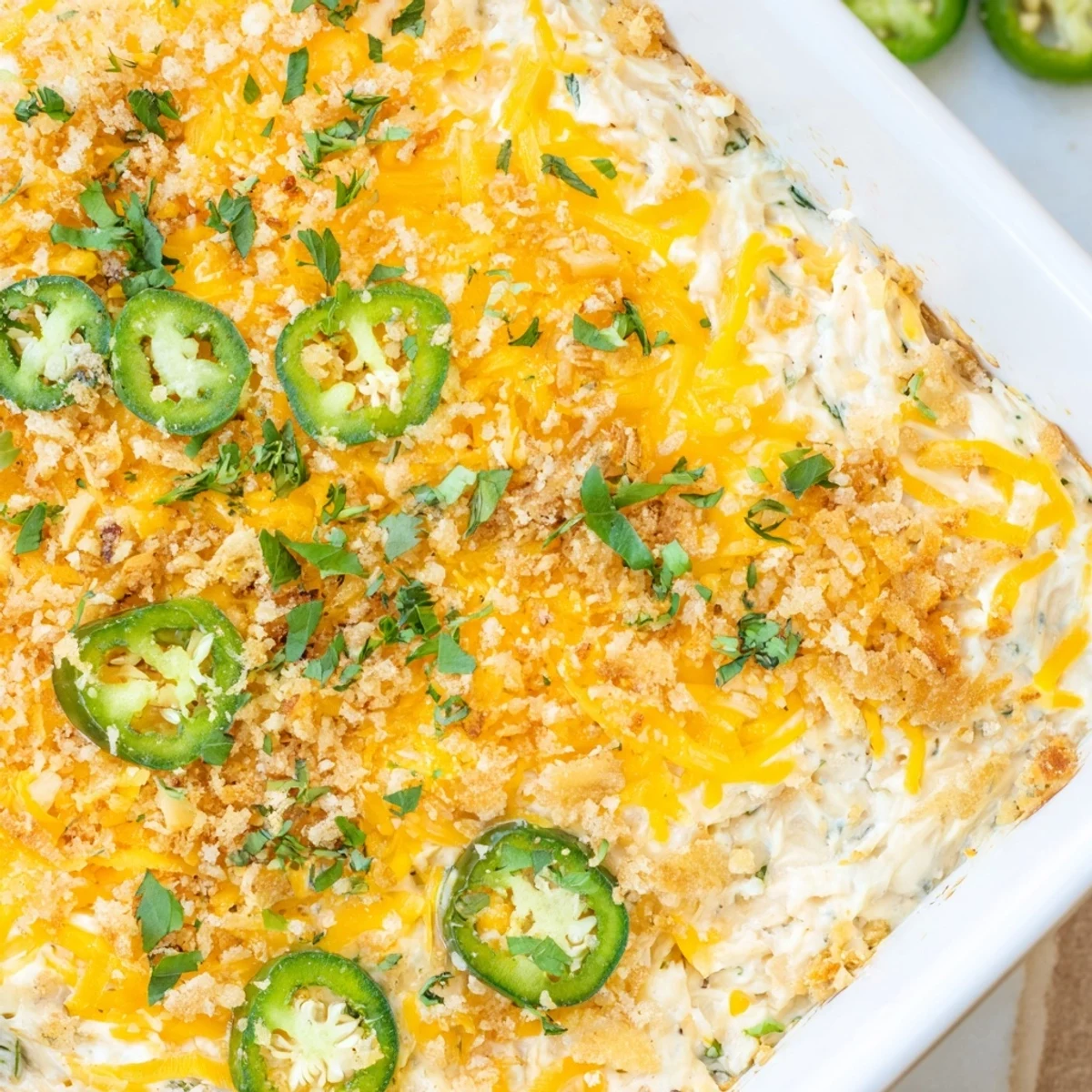 Serving suggestion for Jalapeño Popper Dip with Cream Cheese, paired with sliced baguette and crisp crackers on a rustic board.