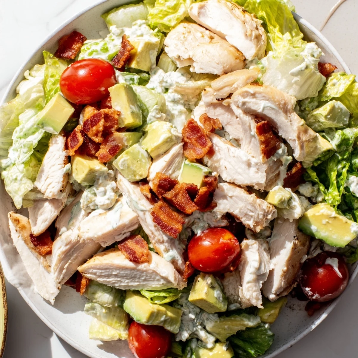 A freshly tossed BLT Chicken Salad features crunchy bacon crumbles and a tangy mayonnaise dressing.