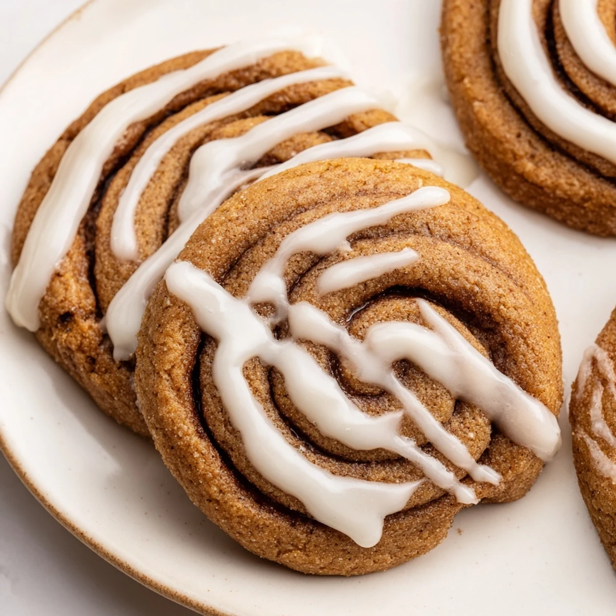 Freshly baked Cinnamon Roll Cookies with a cinnamon sugar swirl, ready to enjoy with a hot cup of coffee.
