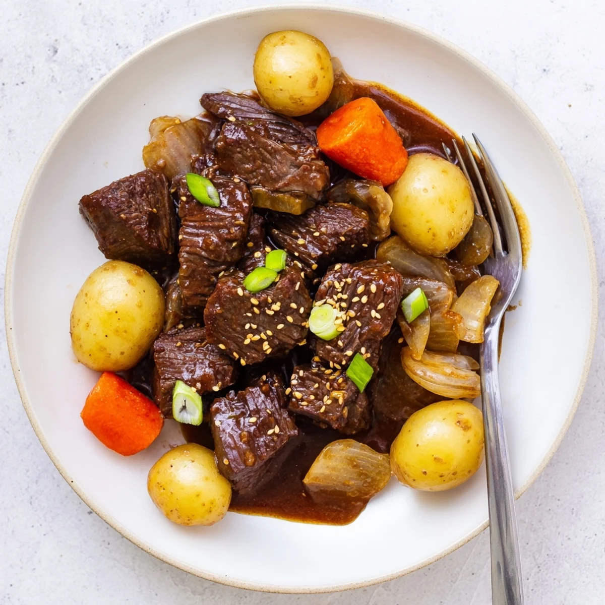 Savory Slow Cooker Korean Beef Pot Roast featuring shredded beef in rich soy garlic gravy over steamed rice