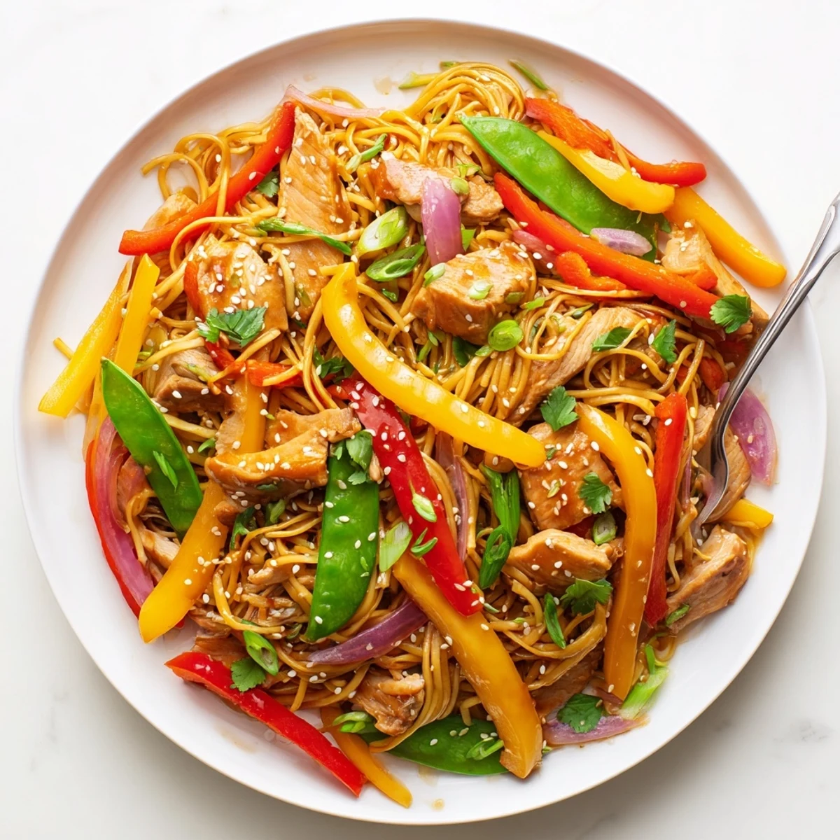Sweet Chilli Turkey Noodle Stir Fry is served steaming hot, garnished with fresh spring onions and sesame seeds, ready for a quick weeknight dinner.