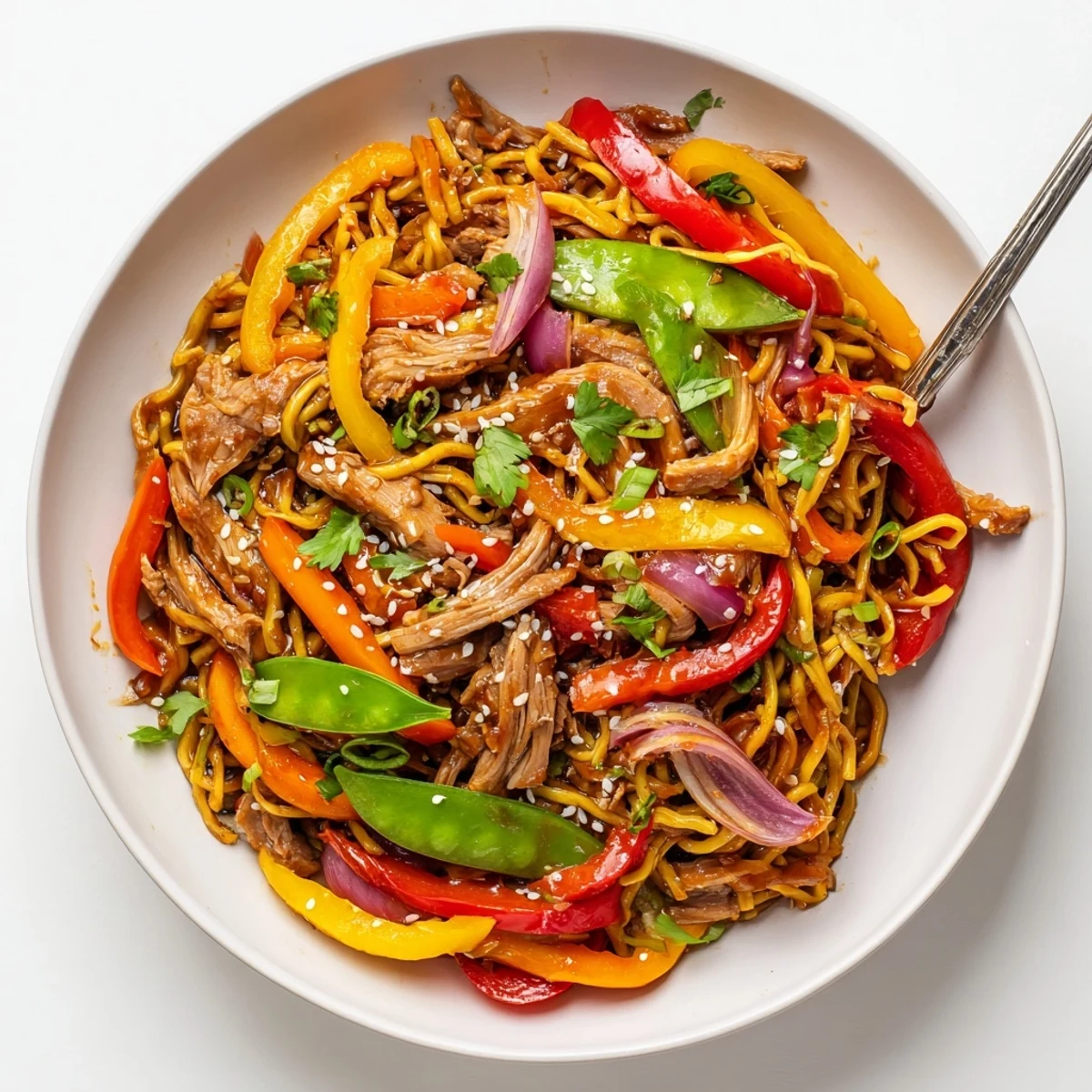 A colorful wok bowl features Sweet Chilli Turkey Noodle Stir Fry with julienned carrots, noodles, and turkey, highlighting a tangy and sweet Asian-inspired flavor.