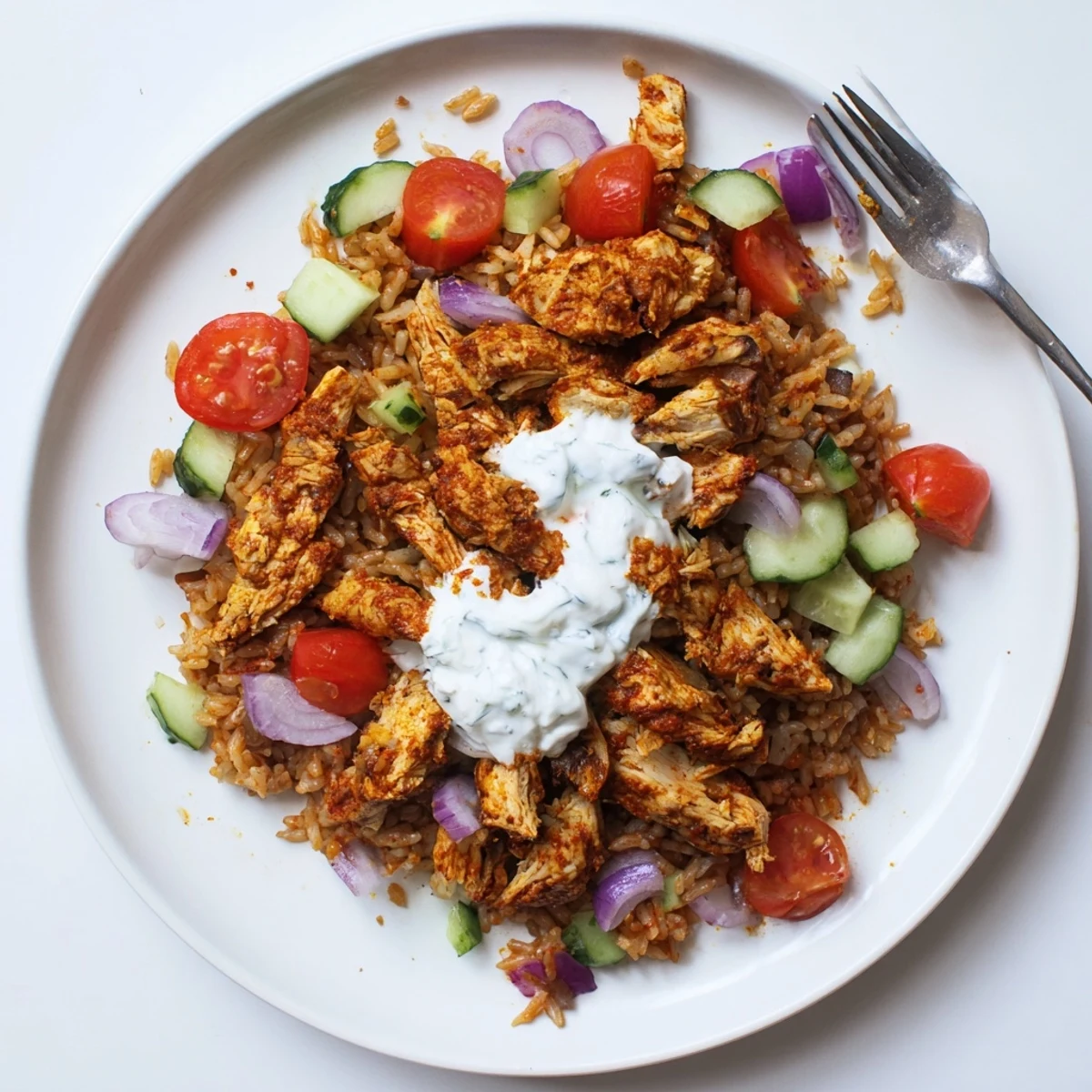 Vibrant chicken shawarma crispy rice salad bowl drizzled with creamy Greek yogurt dressing