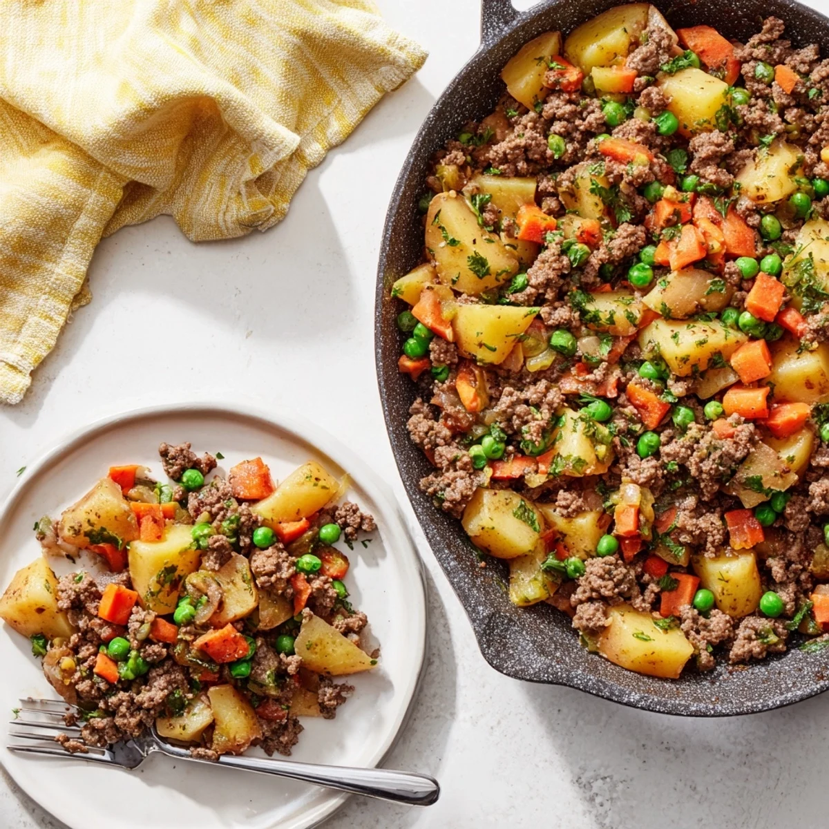 Hearty ground beef and potatoes one pan meal featuring tender carrots and peas