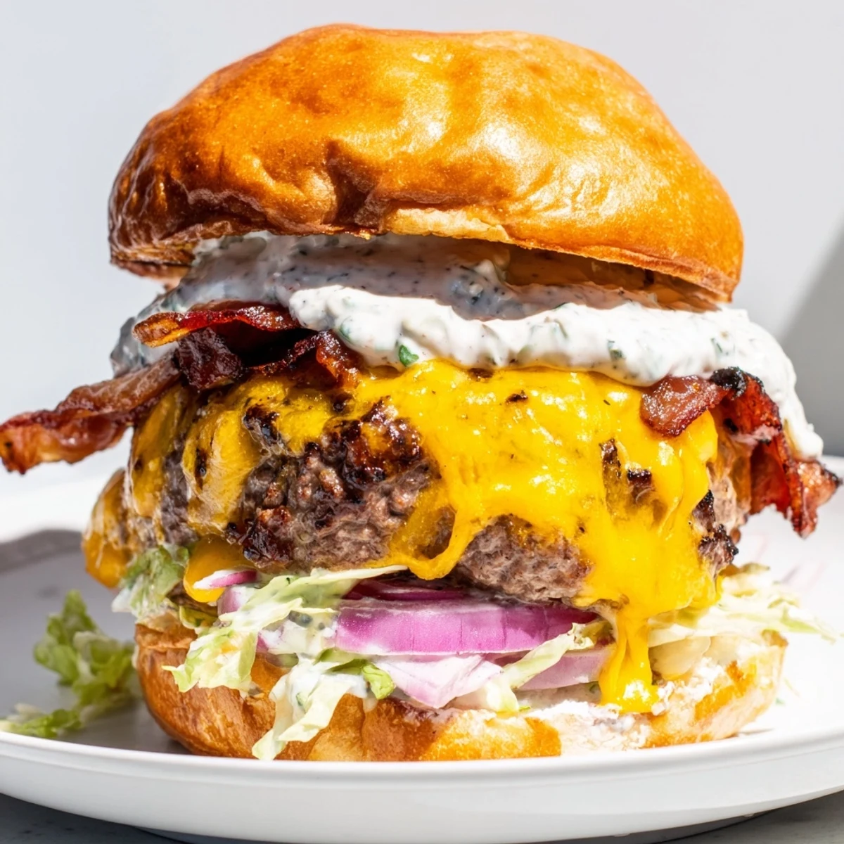 Golden Crack Burger featuring seasoned beef patty topped with crispy bacon and tangy crack sauce