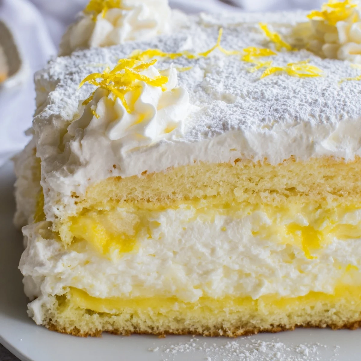 Two round sponge cakes sandwiched between light lemon mascarpone cream, finished with white powdered sugar