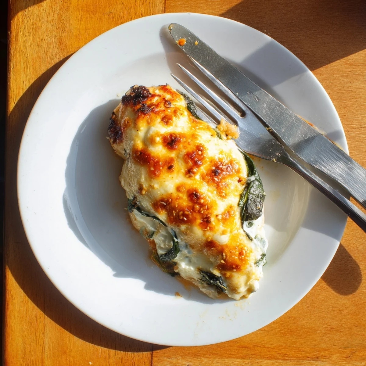 Juicy chicken breasts sliced open to reveal the ricotta spinach filling served with roasted vegetables