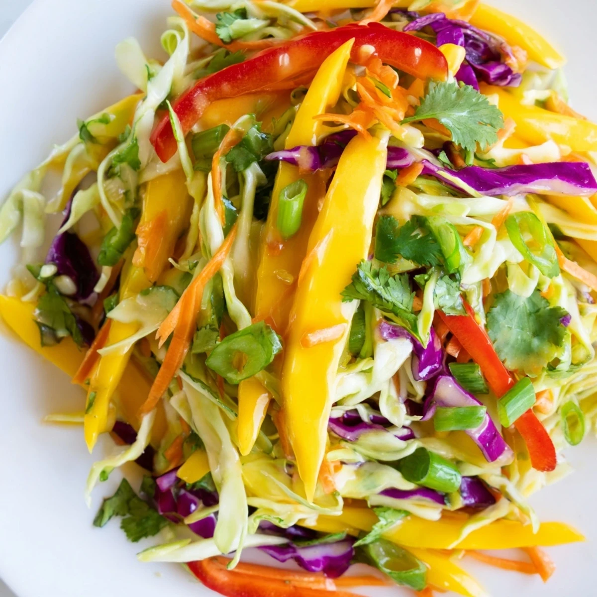 Vibrant mango slaw featuring crisp vegetables drizzled with zesty citrus dressing