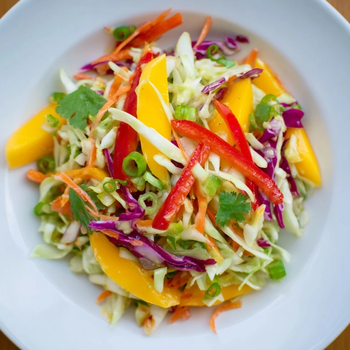 Fresh mango slaw with colorful shredded cabbage in tangy lime dressing