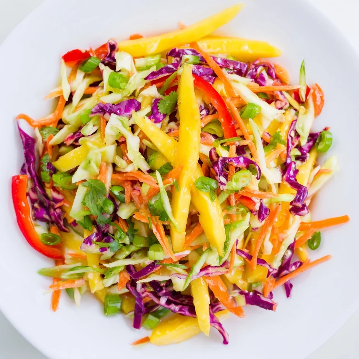 Golden mango slaw topped with cilantro and crisp red cabbage strips