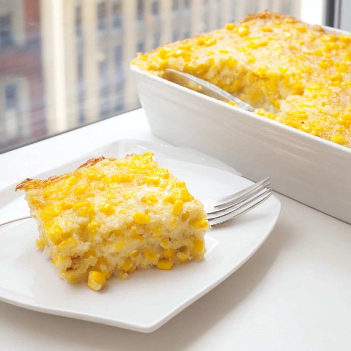 Creamy honey glazed corn casserole fresh from the oven with a glossy honey drizzle on top