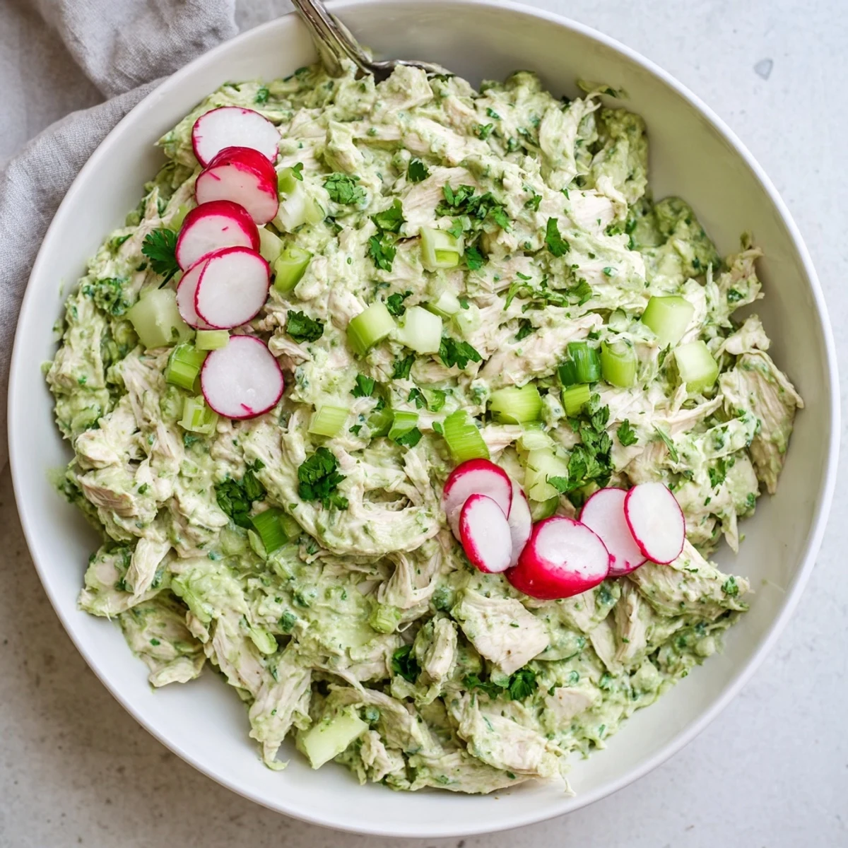 Chunky Green Goddess Chicken Salad Dip topped with sliced radishes and served with crisp vegetable crudités