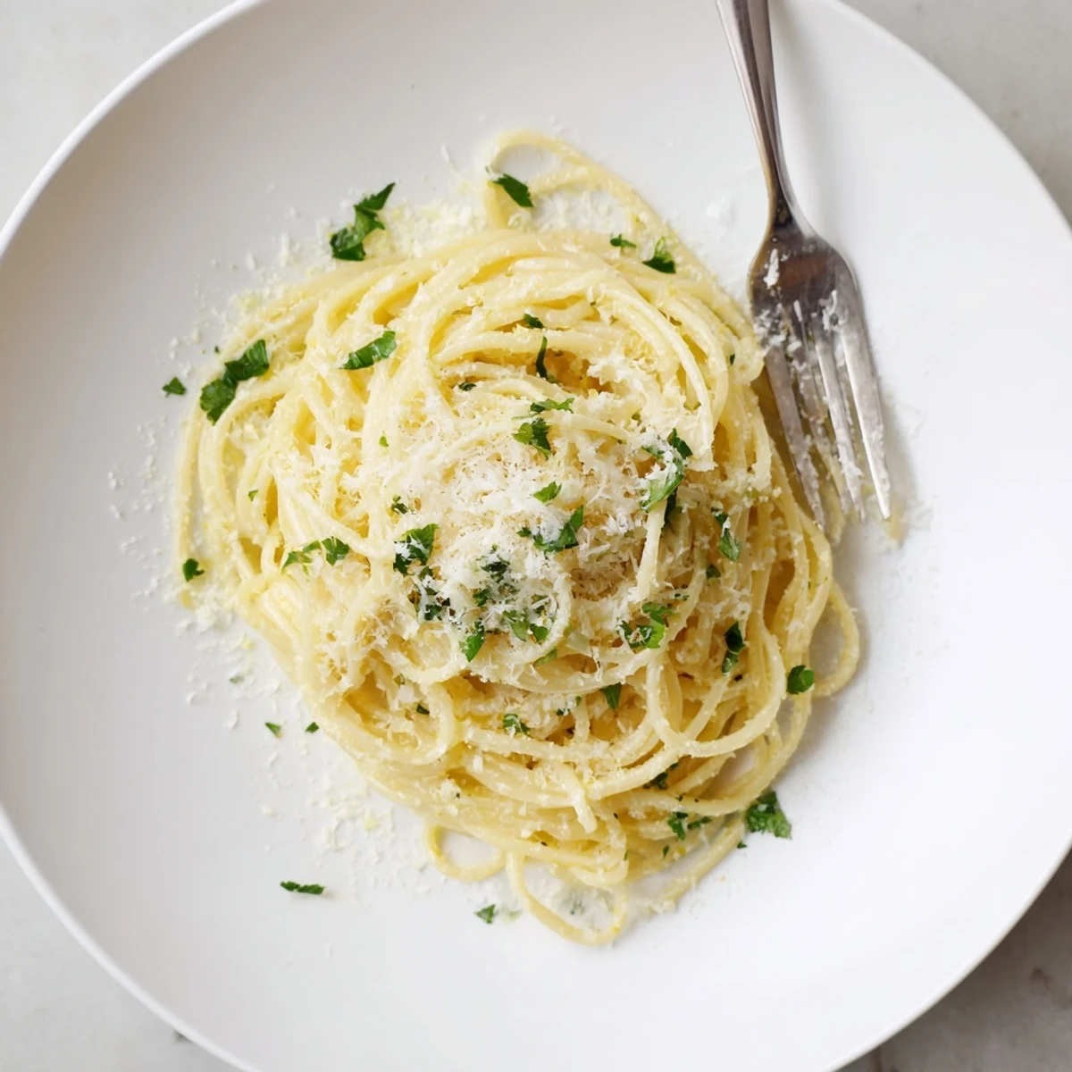 Golden garlic butter pasta tossed in a rich glossy sauce with fresh parsley garnish