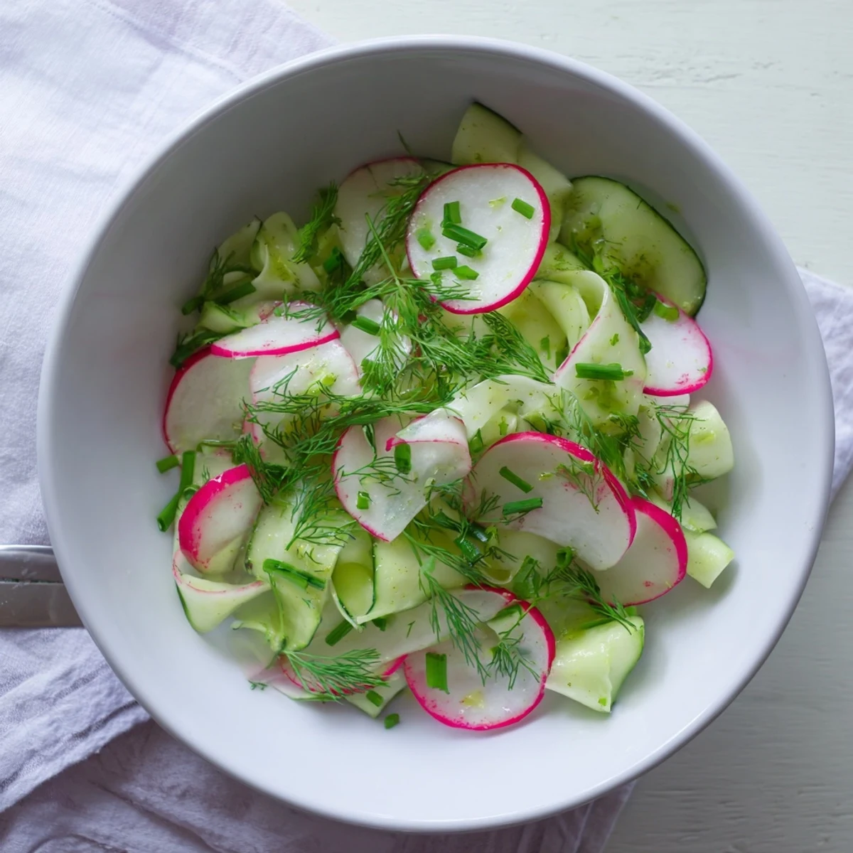Crisp radish and cucumber salad tossed in tangy lemon dressing and topped with chopped green onions