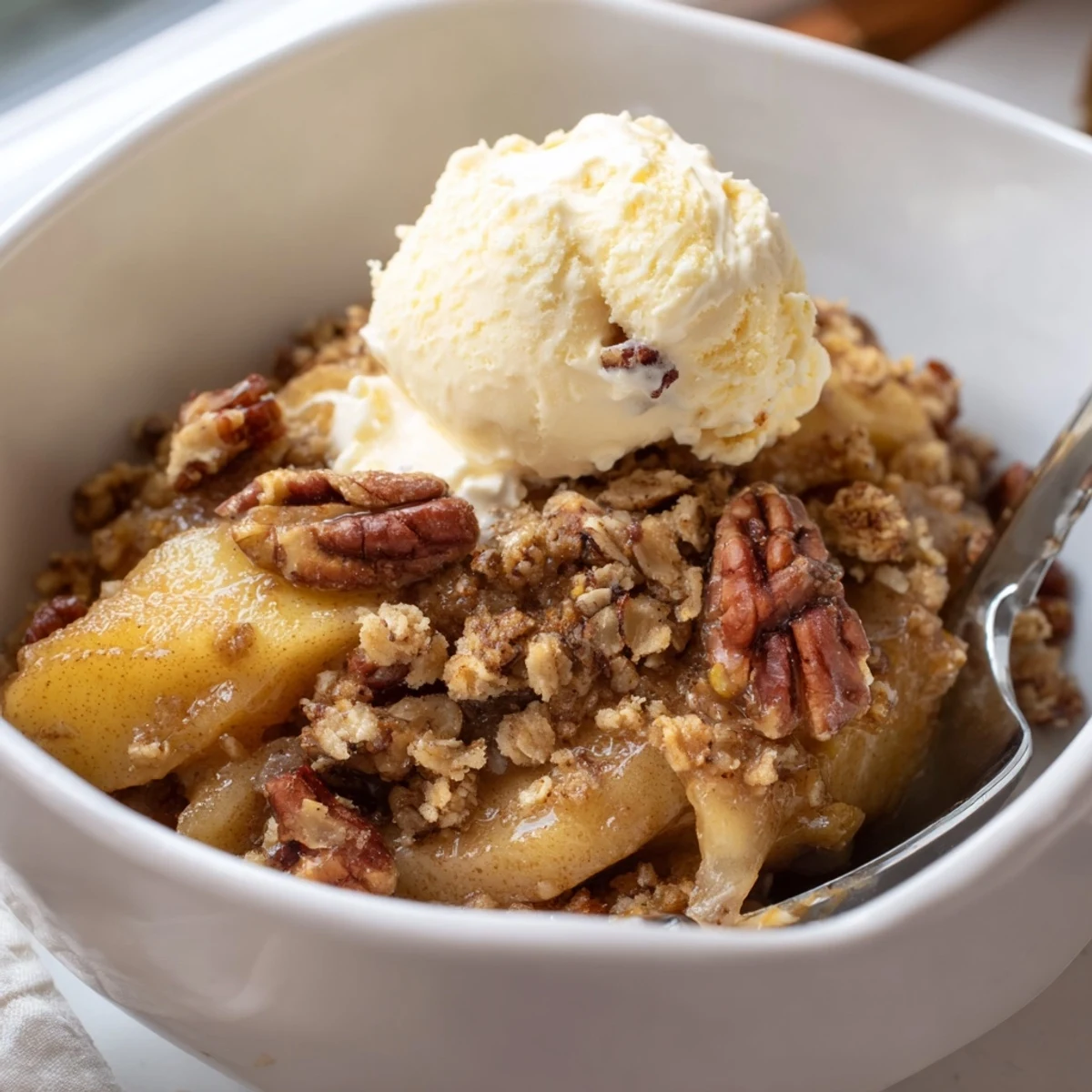 Crockpot apple crisp featuring tender baked apples under a buttery brown sugar crust