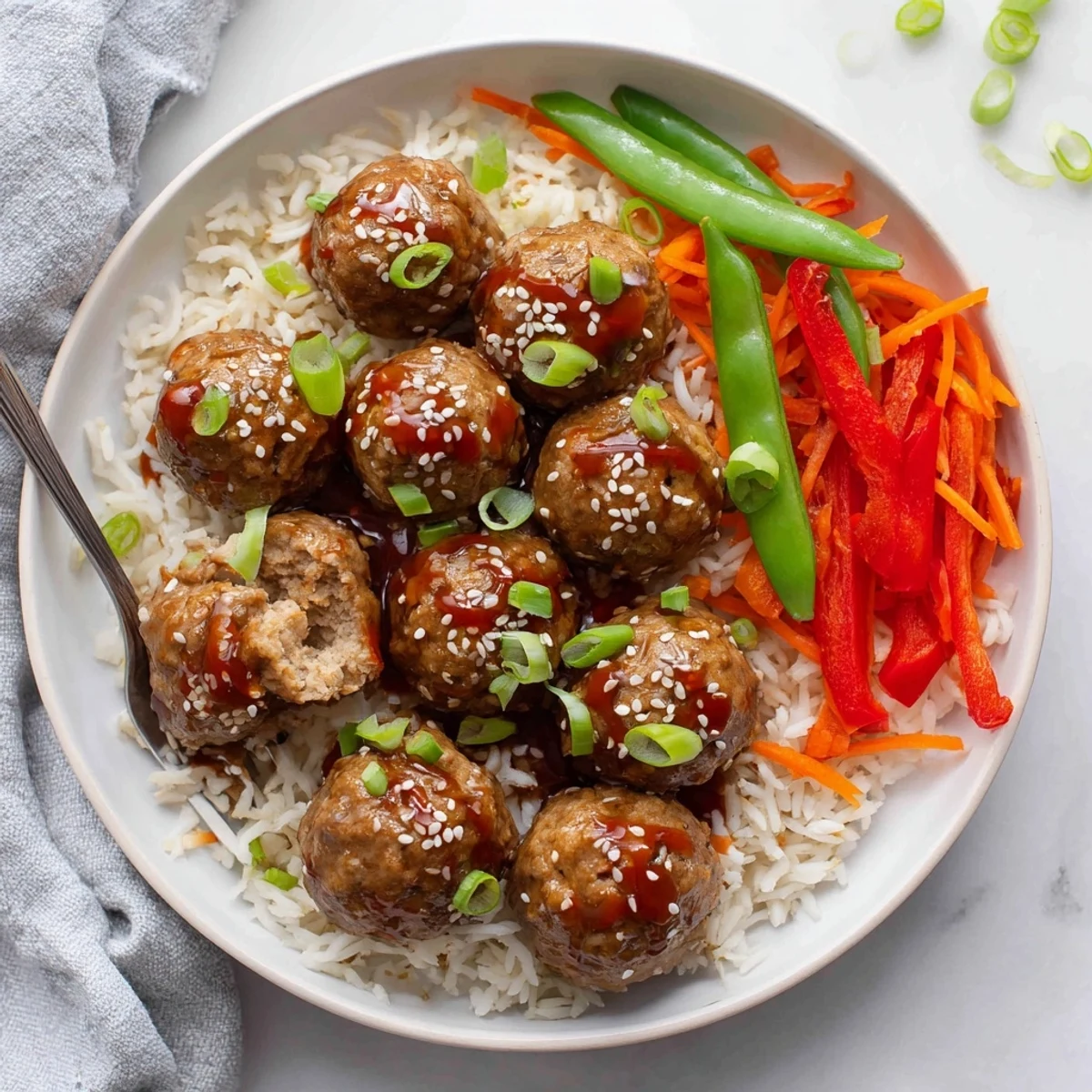 Pan-roasted Hello Fresh Firecracker Meatballs nestled beside crisp sauteed vegetables and rice