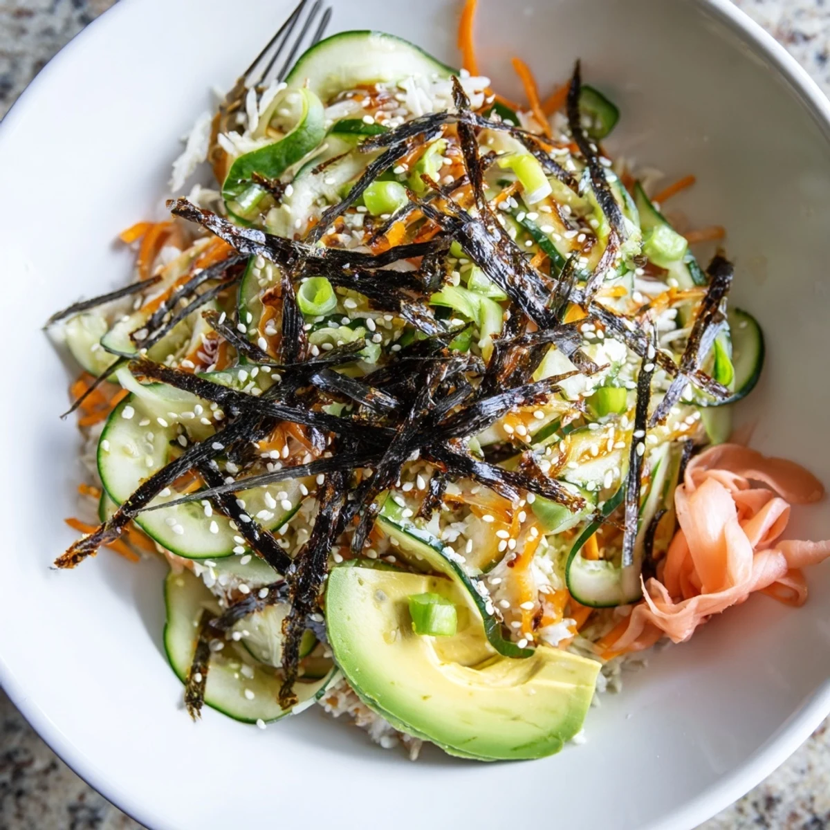 Sushi Cucumber Salad piled in a bowl, glossy cucumbers and seasoned rice