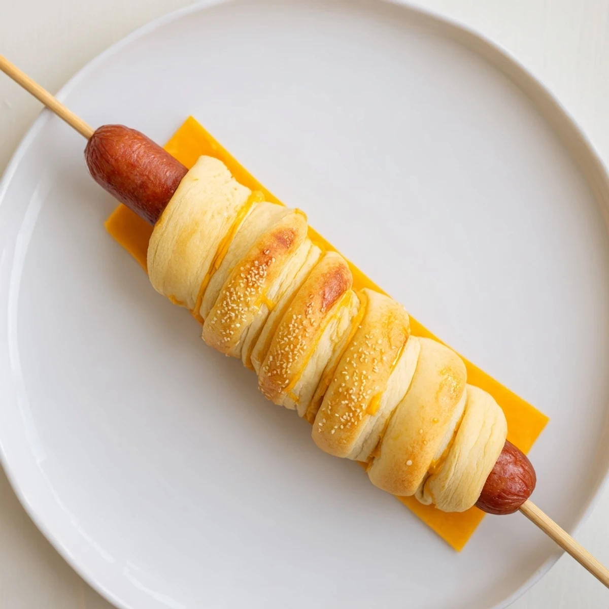 Firecracker Hot Dogs Recipe: golden crescent-wrapped dogs brushed with butter, steaming.