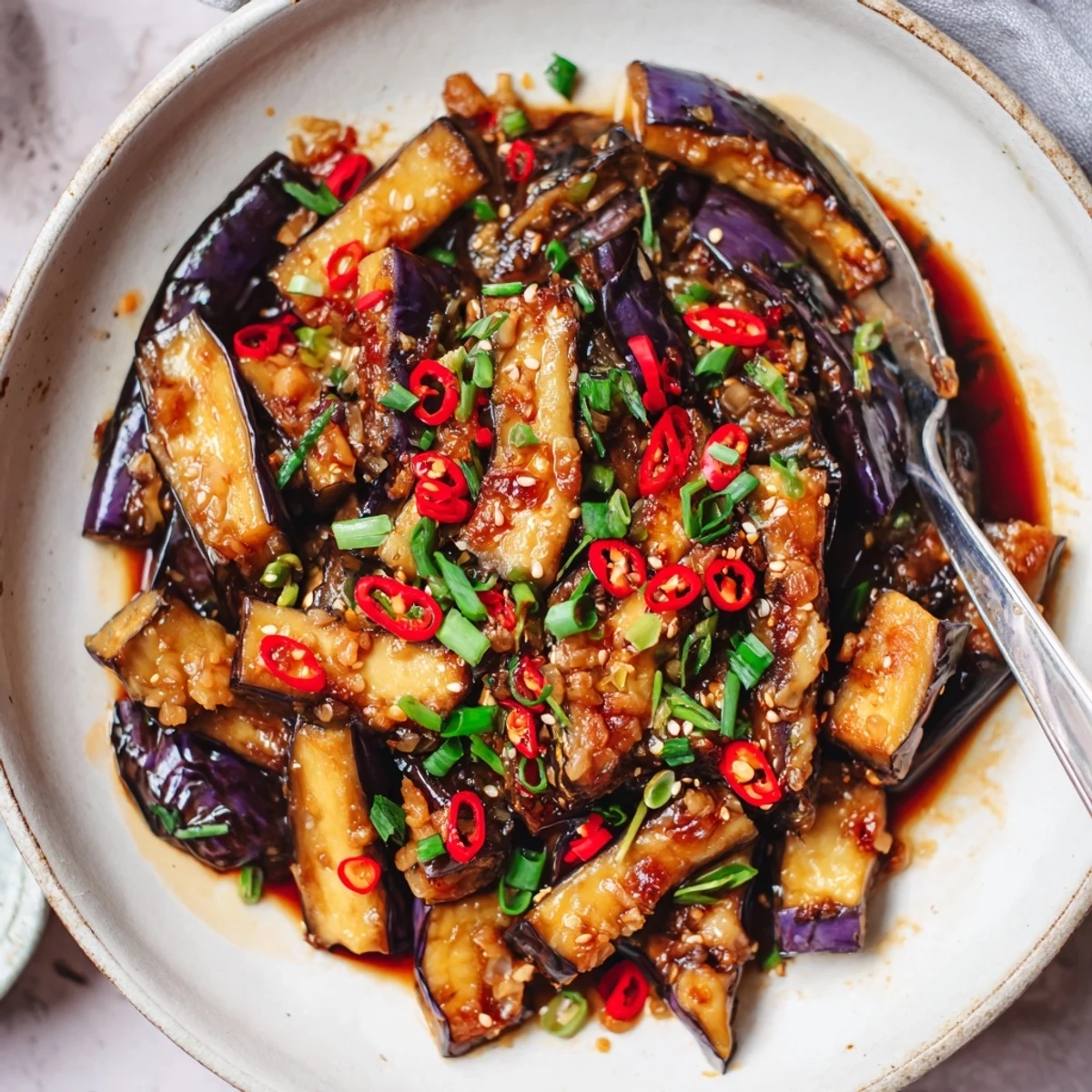 Pan fried Sichuan Style Braised Aubergines bathed in fermented bean paste, garlicky heat