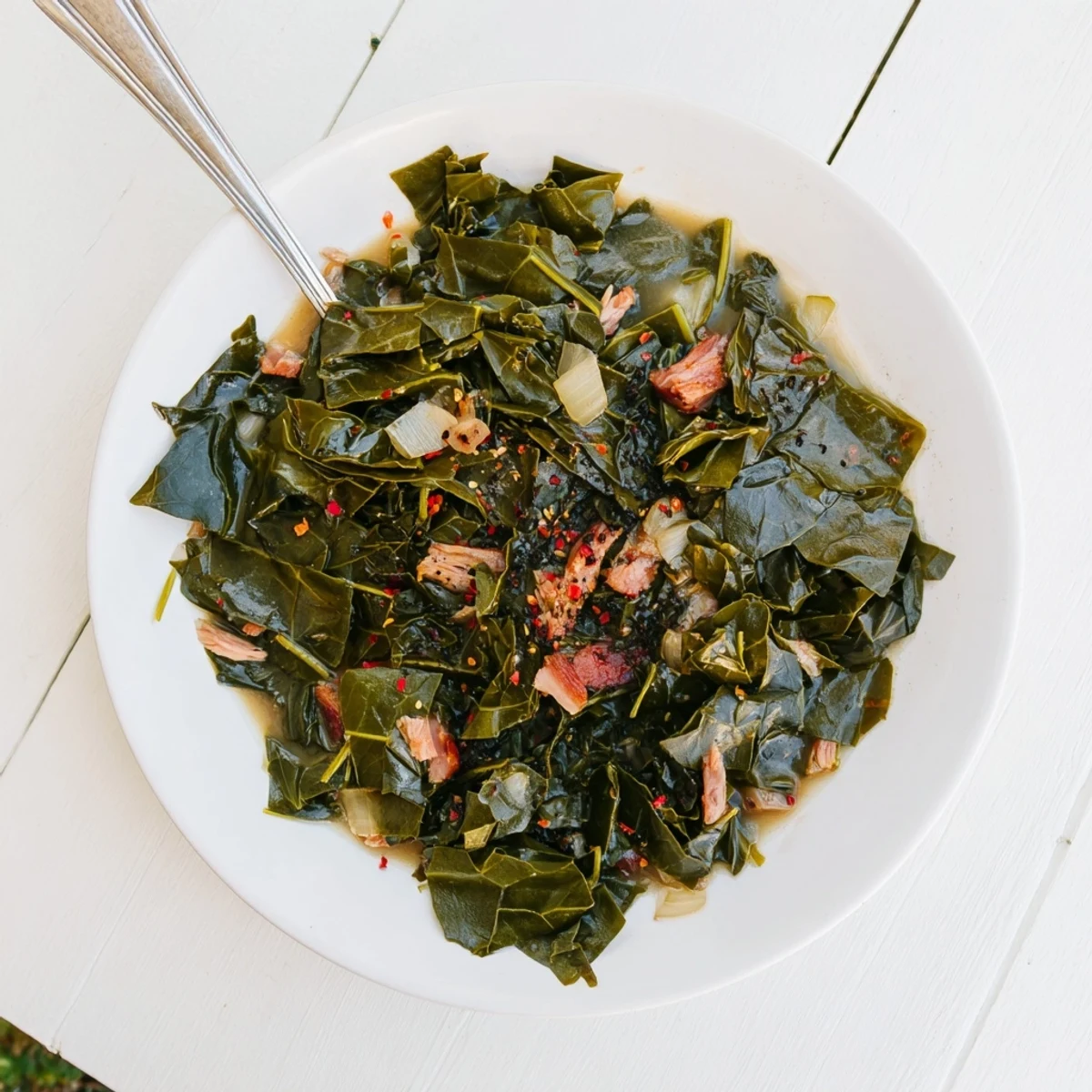 Golden slow-cooked collard greens simmering in a rich broth with tender smoked meat