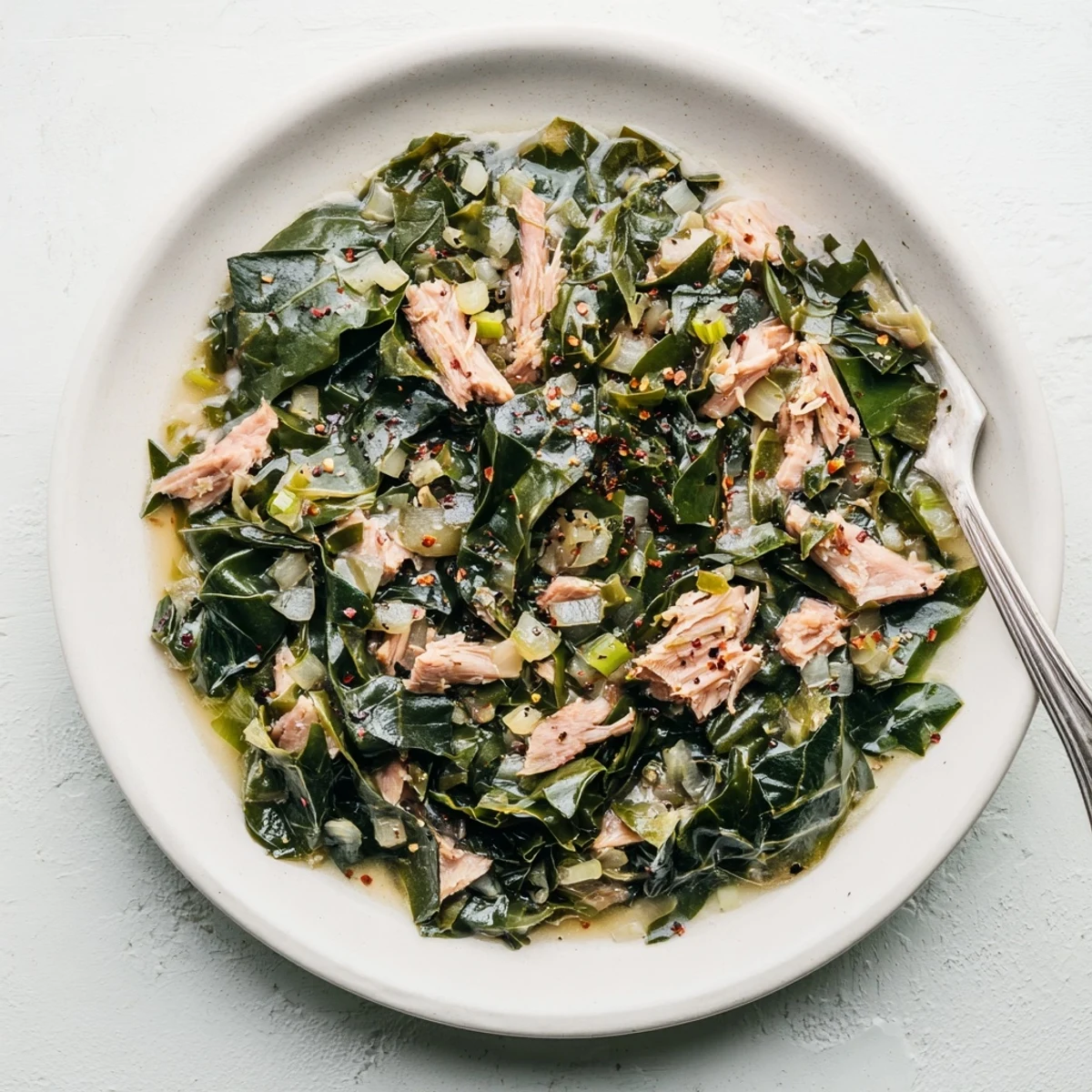 Comforting pot of collard greens slow-simmered until meltingly tender with smoky depth