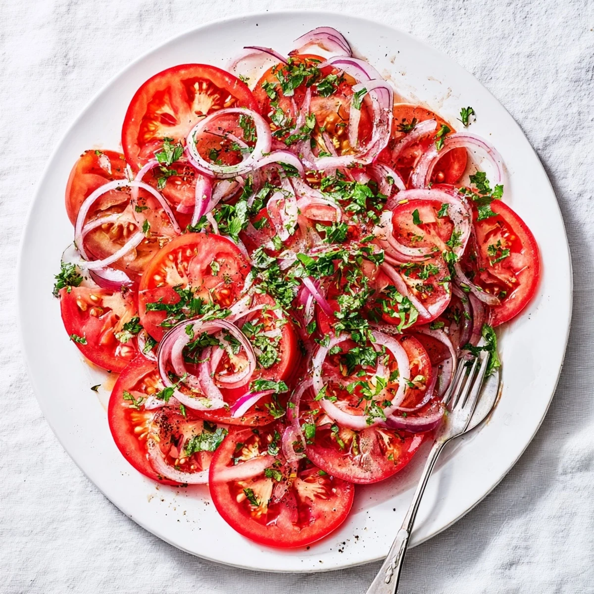 Vibrant tomato and onion salad featuring crisp vegetables, tangy vinaigrette, and chopped parsley perfect for summer dining