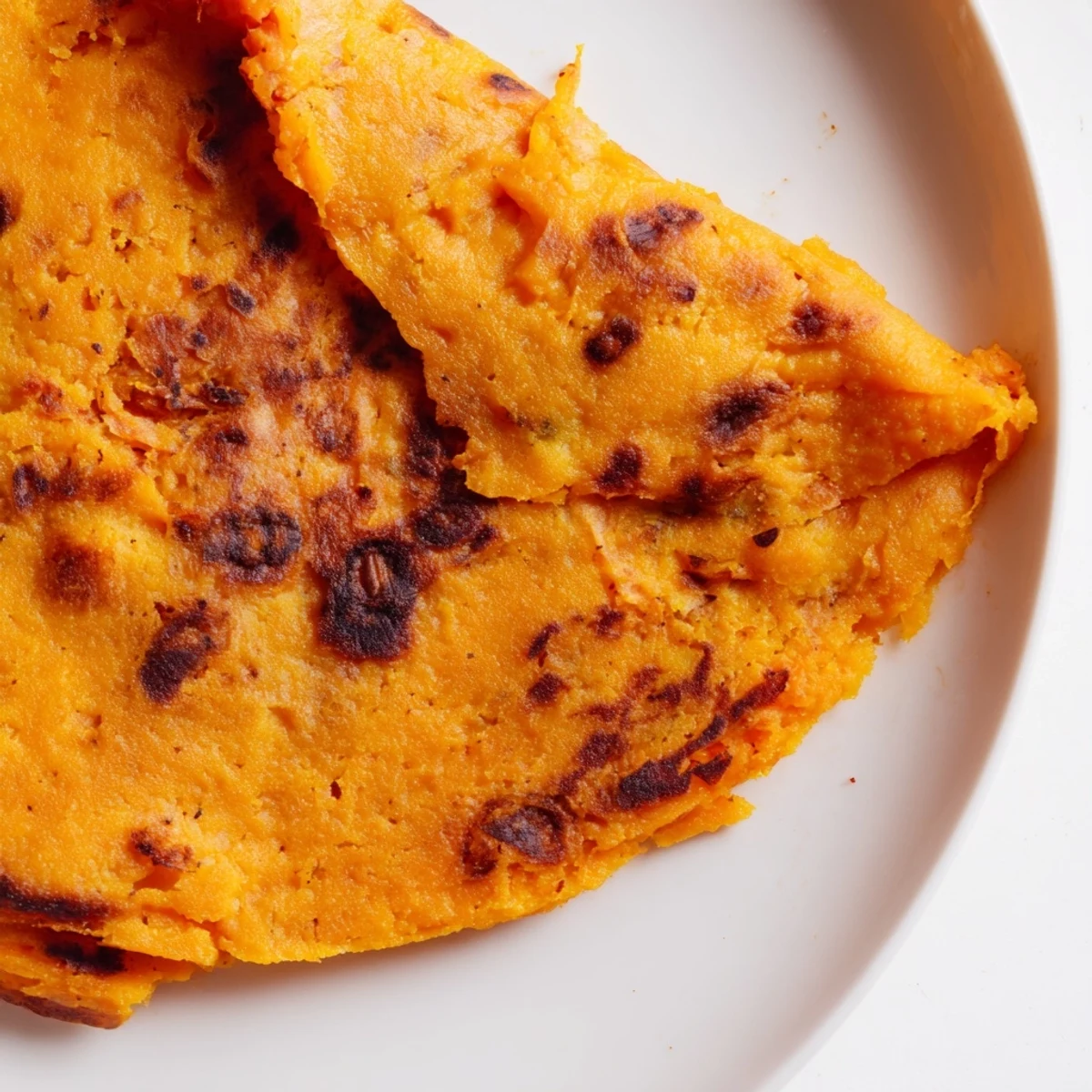 Soft, pliable sweet potato cassava tortillas stacked on a wooden board, ready for gluten-free tacos