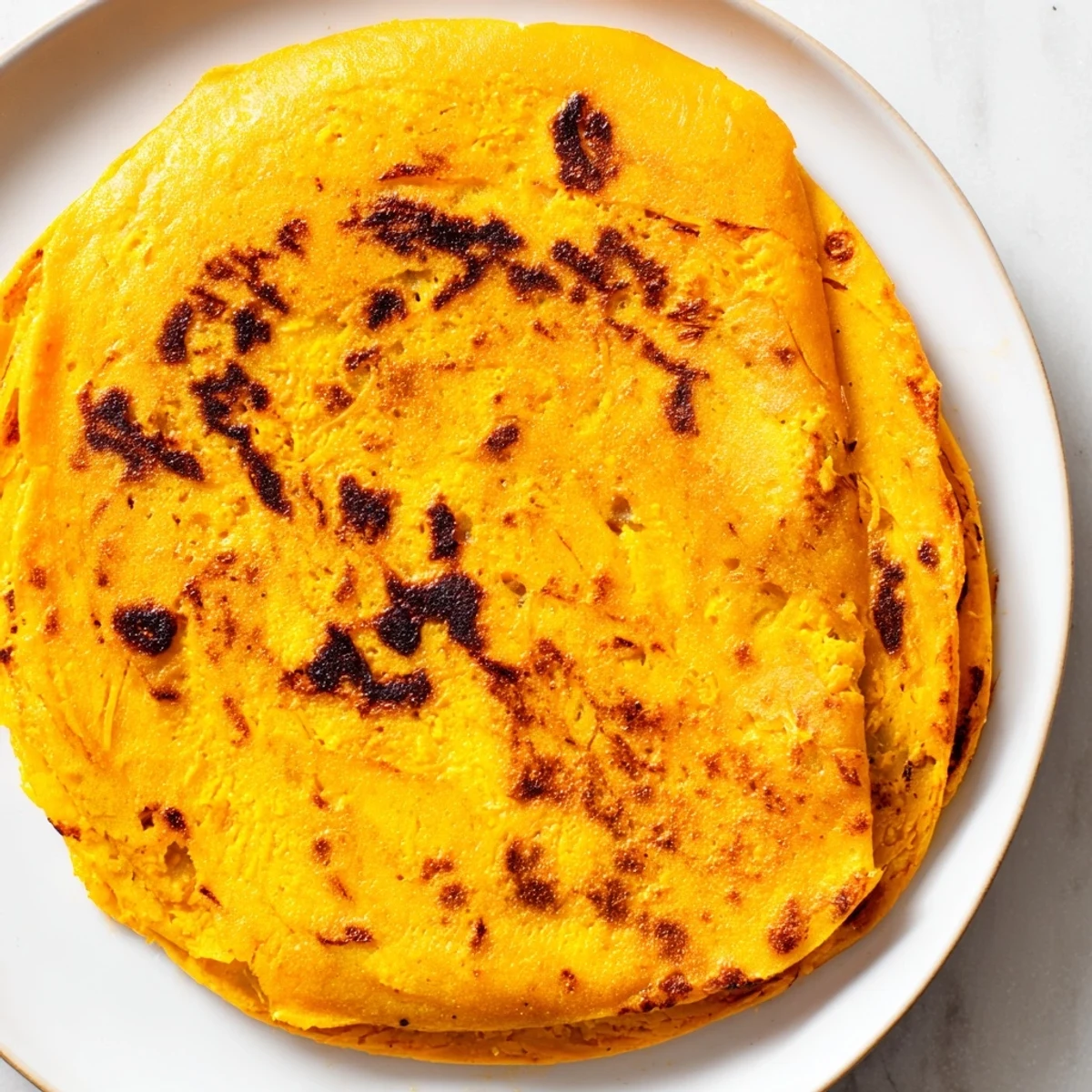 Warm sweet potato cassava tortillas folded with colorful fillings, showing their flexible texture