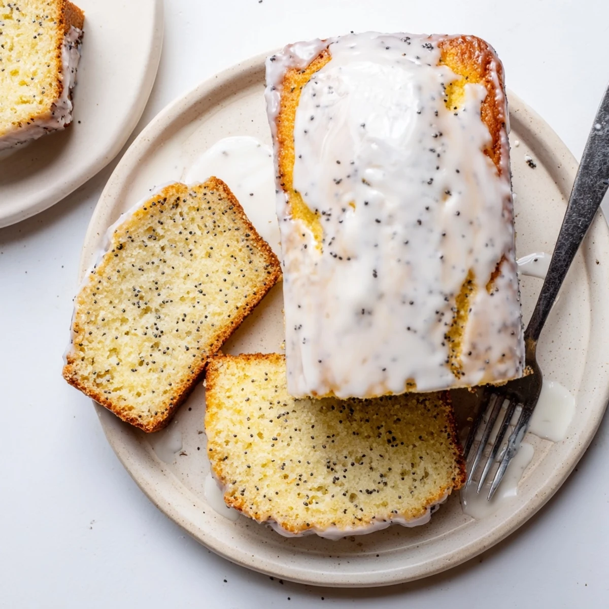 Freshly baked lemon poppy seed bread showing tender crumb and glossy lemon glaze coating