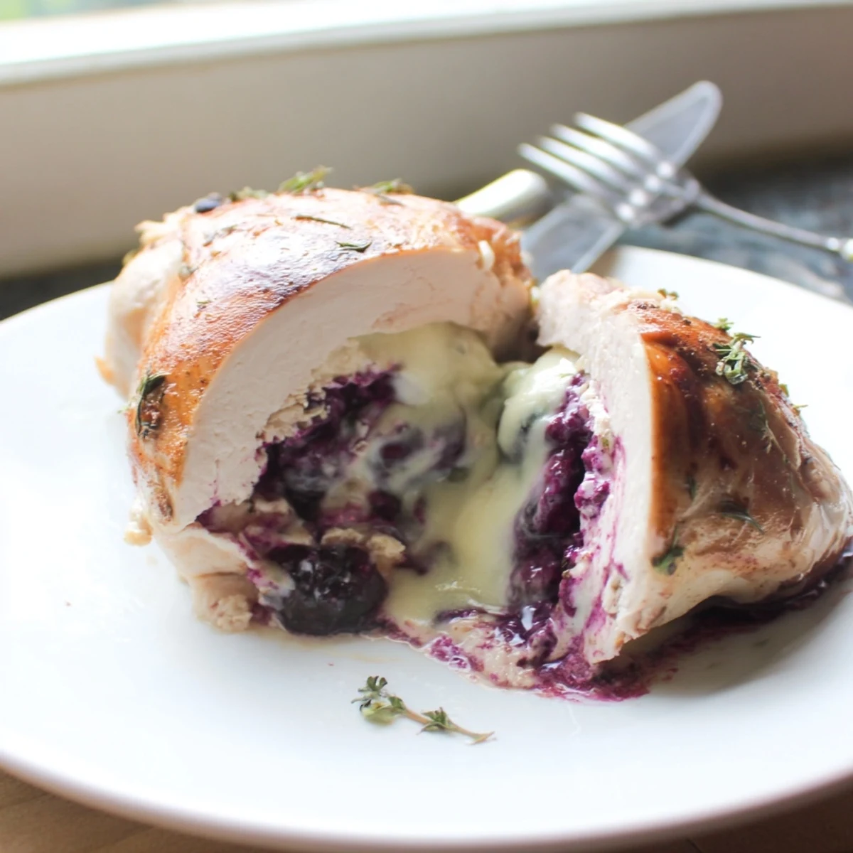 Juicy sliced blackberry jalapeno stuffed chicken revealing vibrant purple berry and jalapeno filling