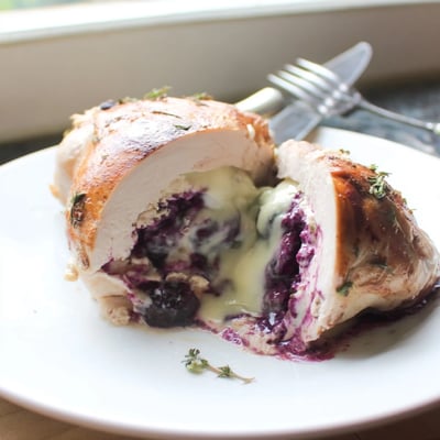 Juicy sliced blackberry jalapeno stuffed chicken revealing vibrant purple berry and jalapeno filling